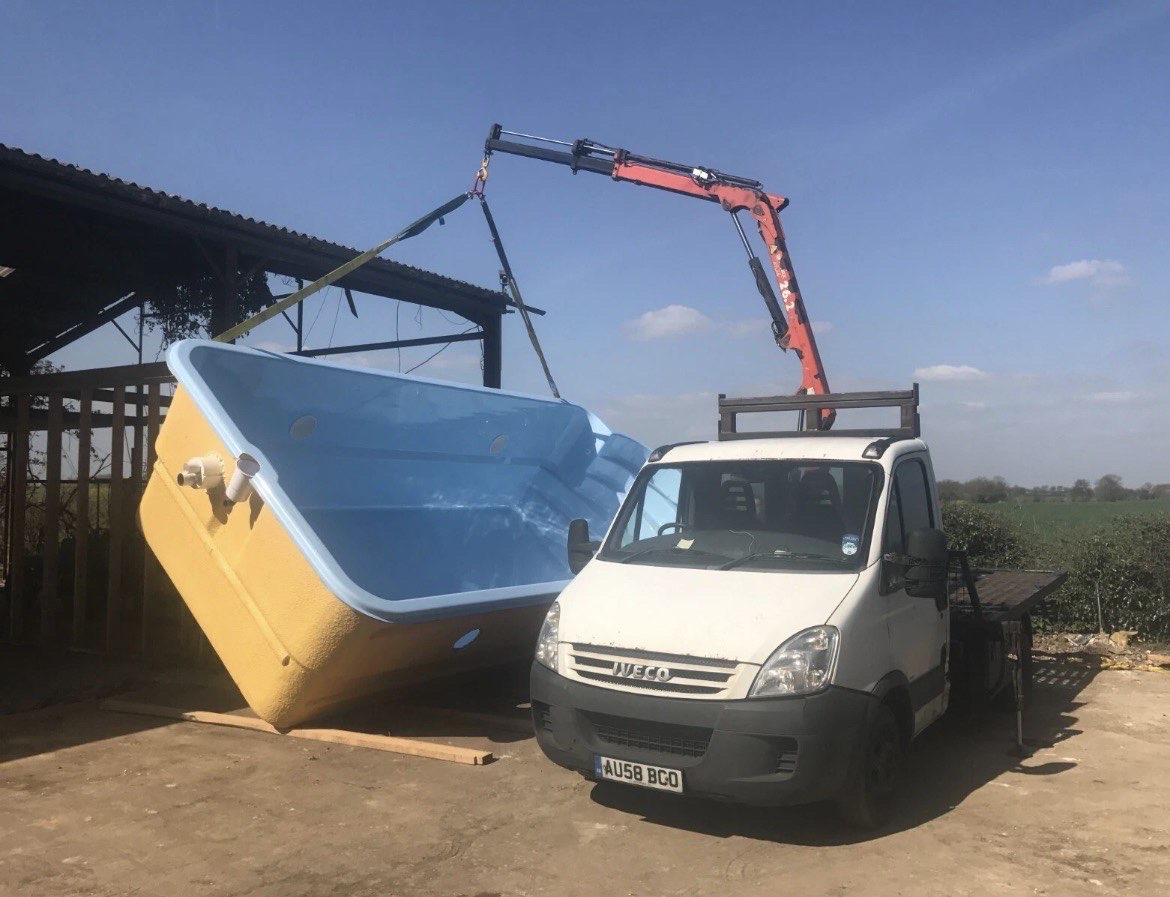 Truck with crane transporting a large item